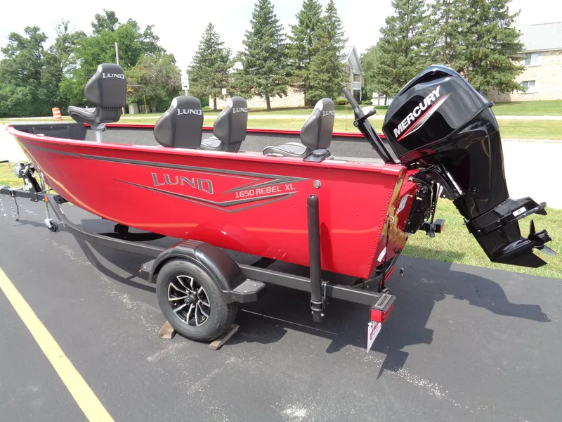 The Image of 2025 Lund 1650 Rebel XL Tiller boat with Mercury engine on trailer. - 0