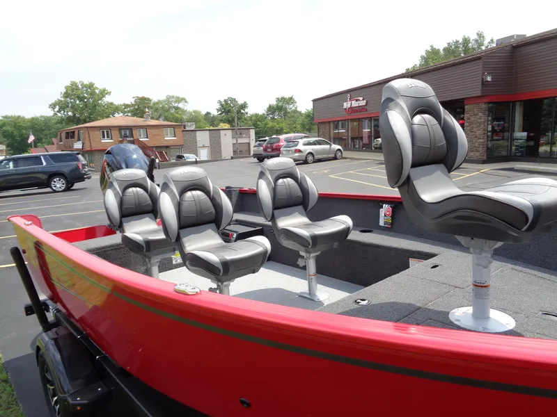 Slide: The Image of 2025 Lund 1650 Rebel XL Tiller boat with four seats in a parking lot. - 4