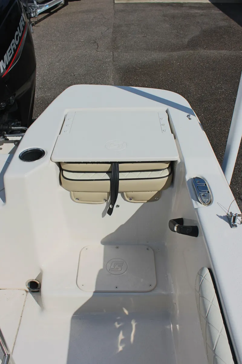 Slide: The Image of 2022 Carolina Skiff 17 LS boat interior with storage compartment and seating. - 12