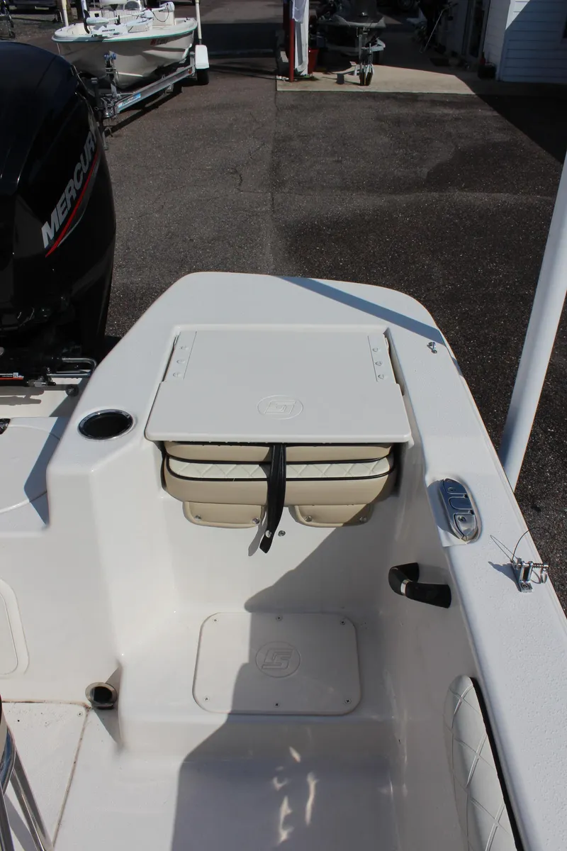 Slide: The Image of 2022 Carolina Skiff 17 LS boat interior with storage compartment and Mercury engine. - 13