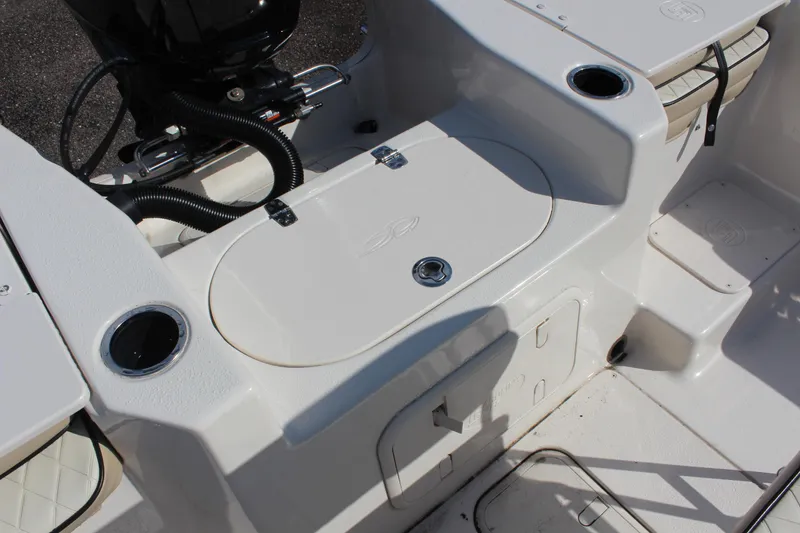 Slide: The Image of 2022 Carolina Skiff 17 LS boat interior with storage compartments and cup holders. - 15