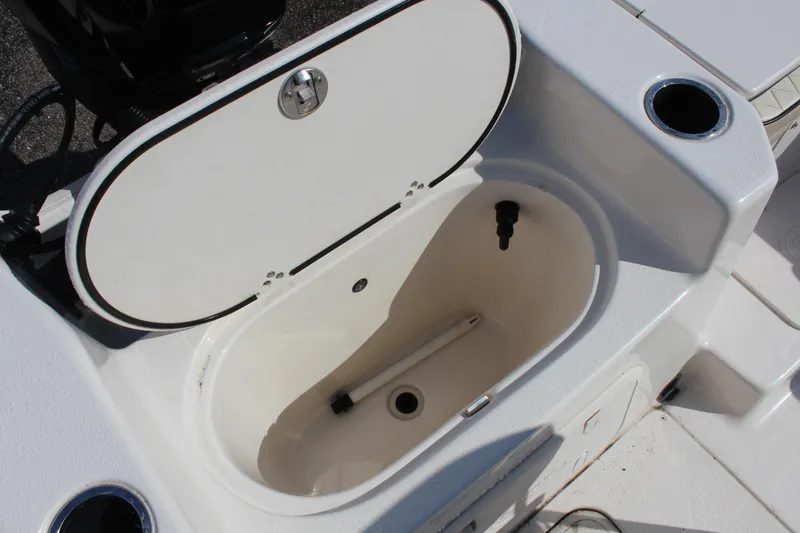 Slide: The Image of 2022 Carolina Skiff 17 LS boat livewell with open lid and cup holders. - 16