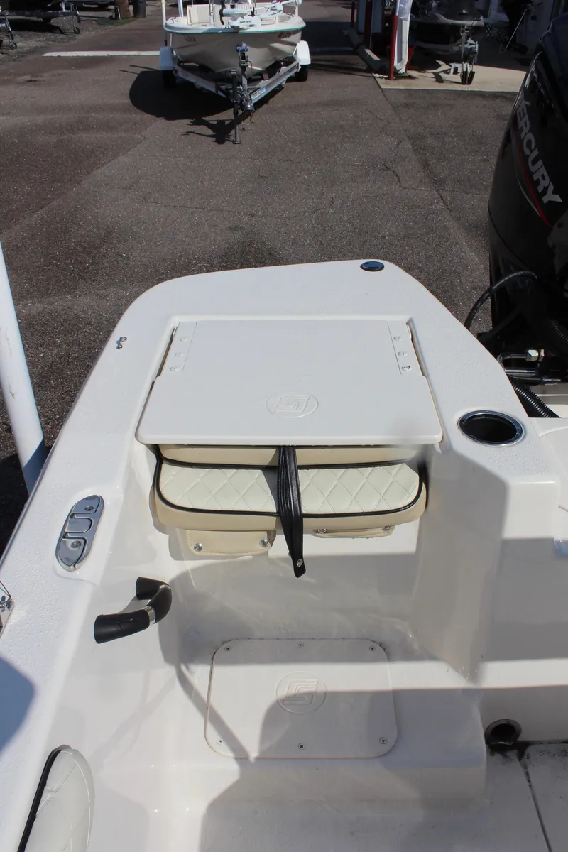 Slide: The Image of 2022 Carolina Skiff 17 LS boat interior with storage compartment and seating. - 17
