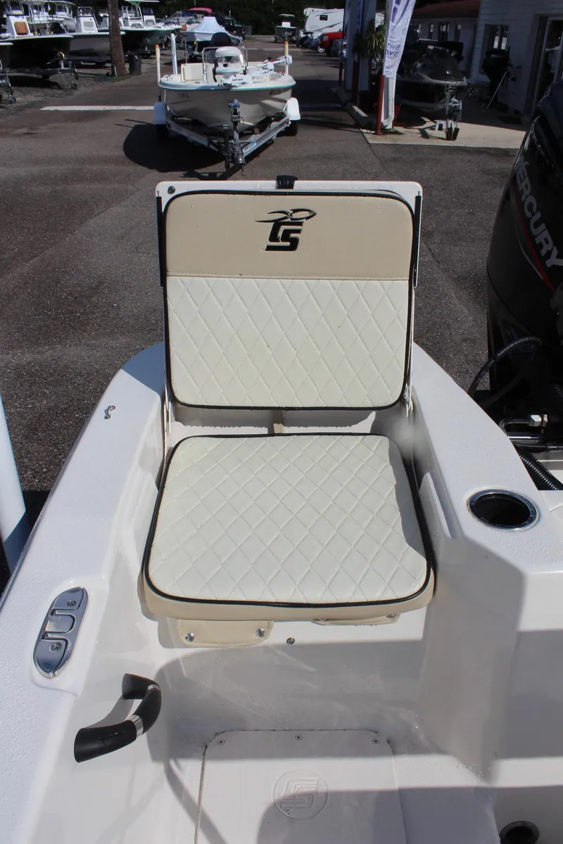 Slide: The Image of 2022 Carolina Skiff 17 LS boat seat with beige upholstery and logo. - 18