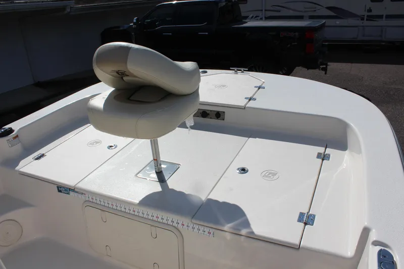 Slide: The Image of 2022 Carolina Skiff 17 LS boat deck with cushioned seat and storage compartments. - 22