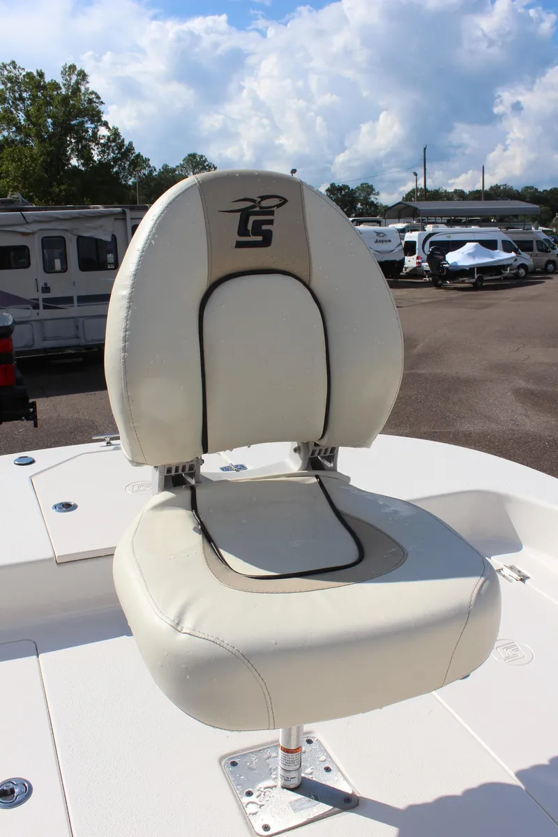 Slide: The Image of 2022 Carolina Skiff 17 LS boat seat with logo, parked outdoors. - 24