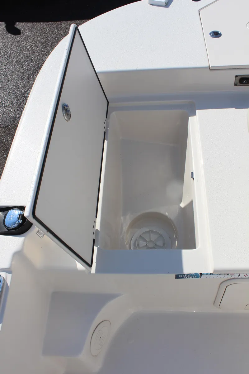Slide: The Image of 2022 Carolina Skiff 17 LS boat storage compartment with open hatch. - 25