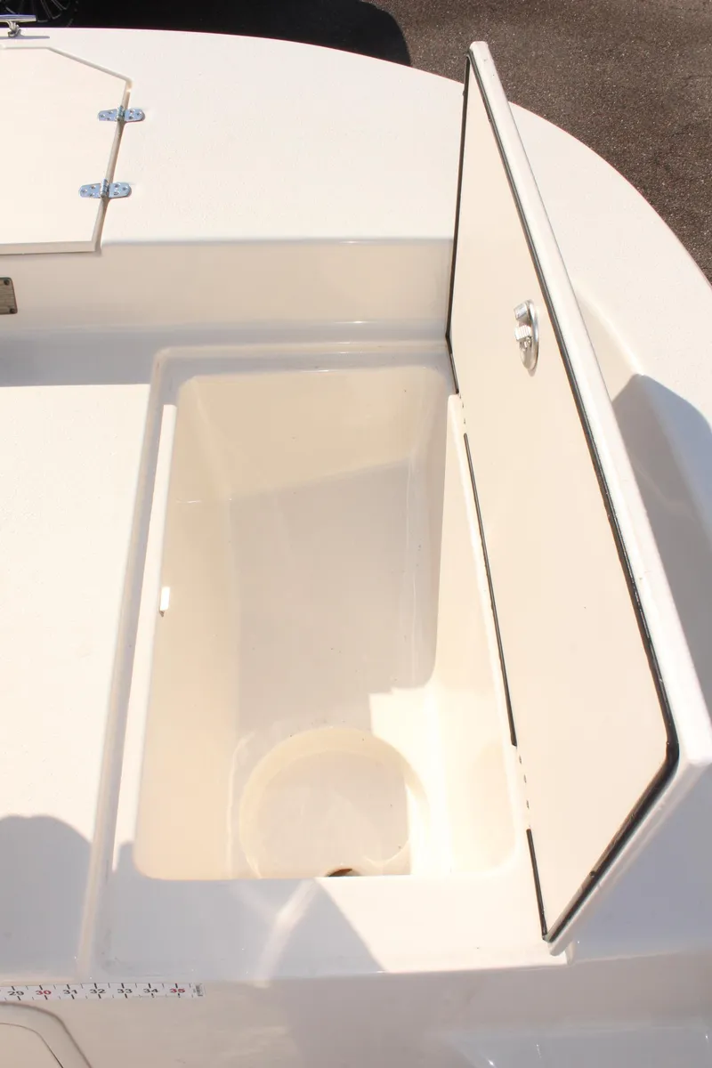 Slide: The Image of 2022 Carolina Skiff 17 LS boat storage compartment with open lid. - 27