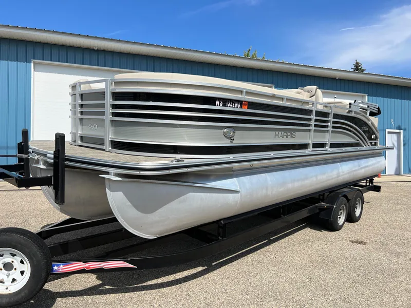 Slide: The Image of 2020 Harris FloteBote H SOL 250 CWDH TT pontoon boat on trailer, parked outdoors. - 38