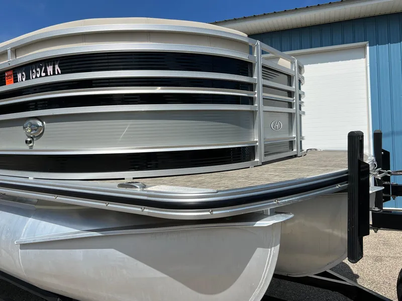 Slide: The Image of 2020 Harris FloteBote H SOL 250 CWDH TT pontoon boat, silver exterior, docked outdoors. - 4