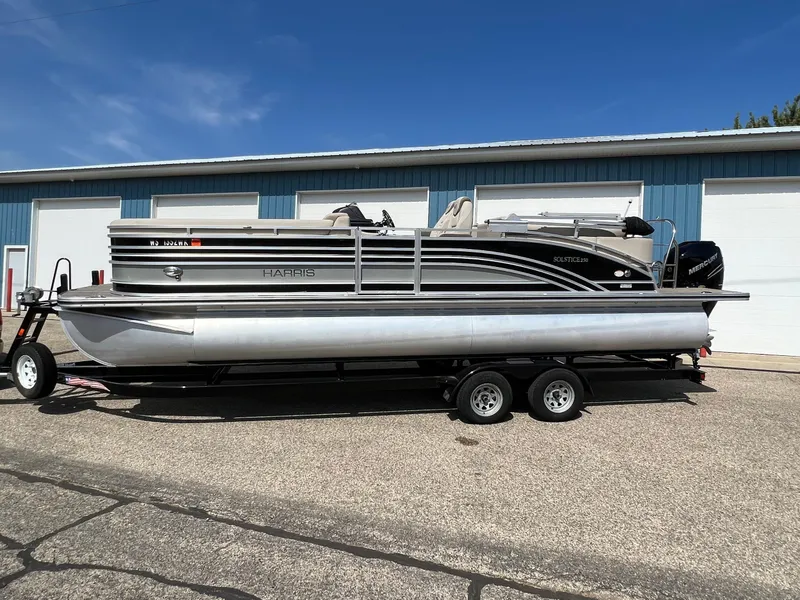 Slide: The Image of 2020 Harris FloteBote H SOL 250 CWDH TT pontoon boat on trailer, parked outdoors. - 40