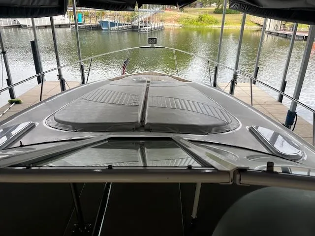 Slide: The Image of 2001 Cruisers Yachts 3470 Express docked at a marina, view from the deck. - 12