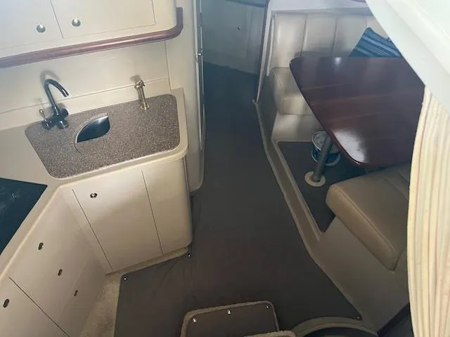 Slide: The Image of 2001 Cruisers Yachts 3470 Express interior with kitchenette and dining area. - 13