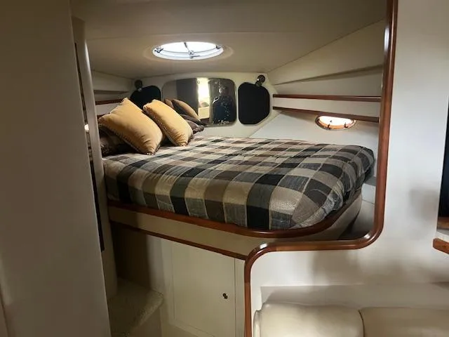 Slide: The Image of Luxurious cabin interior of 2001 Cruisers Yachts 3470 Express with cozy bed and pillows. - 14