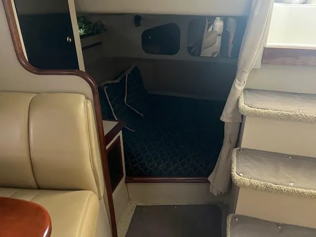 Slide: The Image of 2001 Cruisers Yachts 3470 Express cabin interior with cozy sleeping area and stairs. - 15