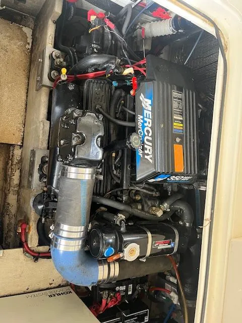 Slide: The Image of 2001 Cruisers Yachts 3470 Express engine compartment with Mercury motor. - 19