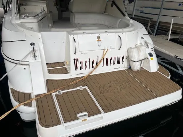 Slide: The Image of 2001 Cruisers Yachts 3470 Express with "Wasted Income" name on the stern. - 2