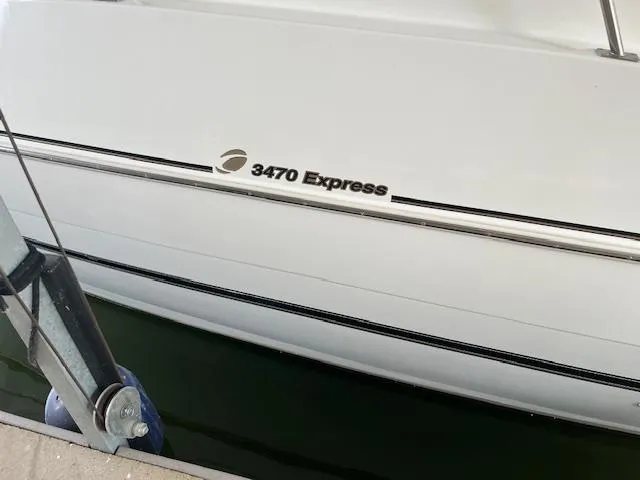 Slide: The Image of 2001 Cruisers Yachts 3470 Express boat side view at dock. - 3