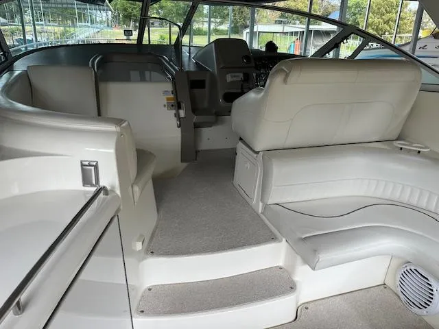 Slide: The Image of 2001 Cruisers Yachts 3470 Express interior with white seating and helm. - 5