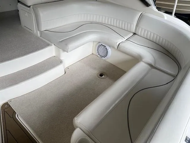 Slide: The Image of 2001 Cruisers Yachts 3470 Express interior with white seating and carpeted flooring. - 6