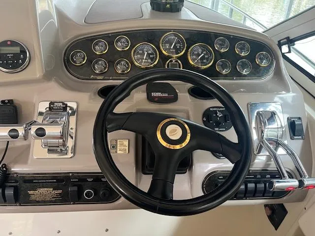 Slide: The Image of 2001 Cruisers Yachts 3470 Express dashboard with steering wheel and control gauges. - 8