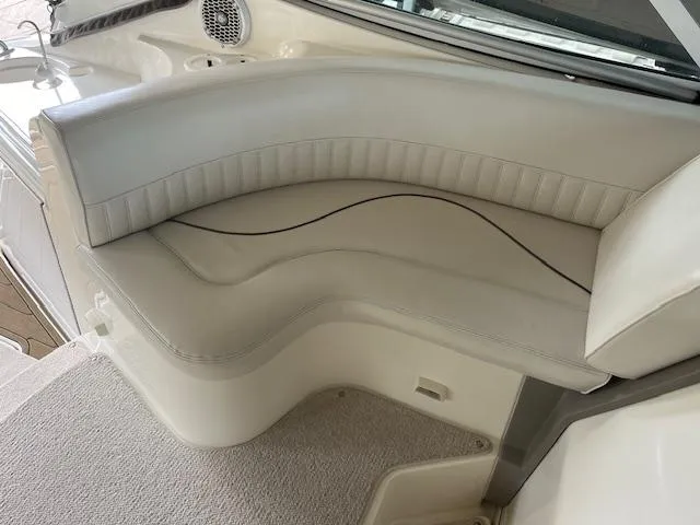 Slide: The Image of 2001 Cruisers Yachts 3470 Express interior seating with white upholstery. - 9