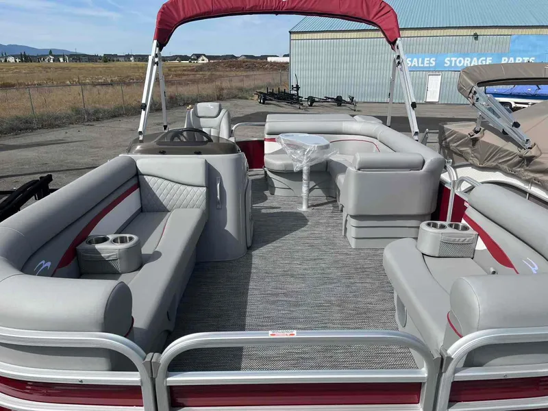 Slide: The Image of 2024 Bennington 20 SVL pontoon boat with spacious seating and red canopy. - 11