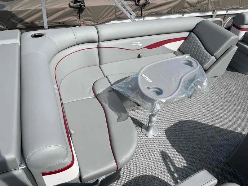 Slide: The Image of 2024 Bennington 20 SVL pontoon boat interior with gray seating and table. - 13