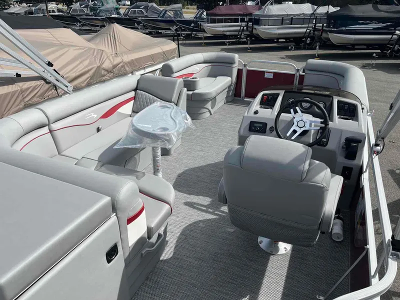 Slide: The Image of 2024 Bennington 20 SVL pontoon boat interior with gray seating and steering console. - 15