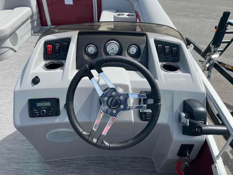 Slide: The Image of 2024 Bennington 20 SVL boat dashboard with steering wheel and controls. - 17