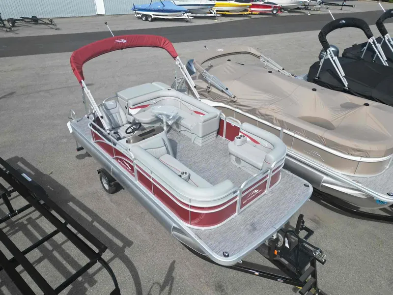 Slide: The Image of 2024 Bennington 20 SVL pontoon boat with red canopy and spacious seating. - 4