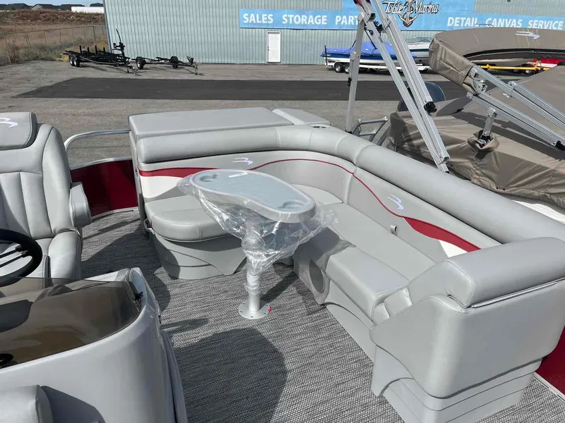 Slide: The Image of 2024 Bennington 20 SVL pontoon boat interior with gray seating and table. - 9