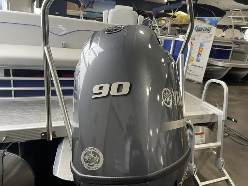 Slide: The Image of 2023 Bennington 218 SLJ with Yamaha 90 engine, showcased in a boat dealership. - 11