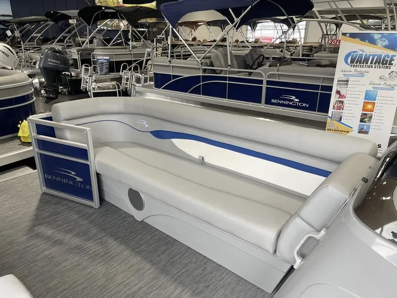 Slide: The Image of 2023 Bennington 218 SLJ pontoon boat interior with gray seating and blue accents. - 5