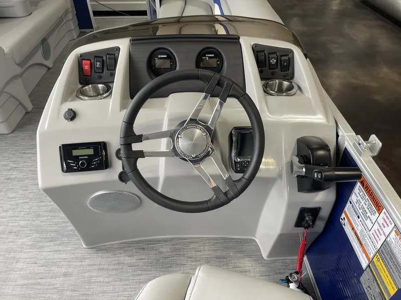 Slide: The Image of 2023 Bennington 218 SLJ boat dashboard with steering wheel and controls. - 8
