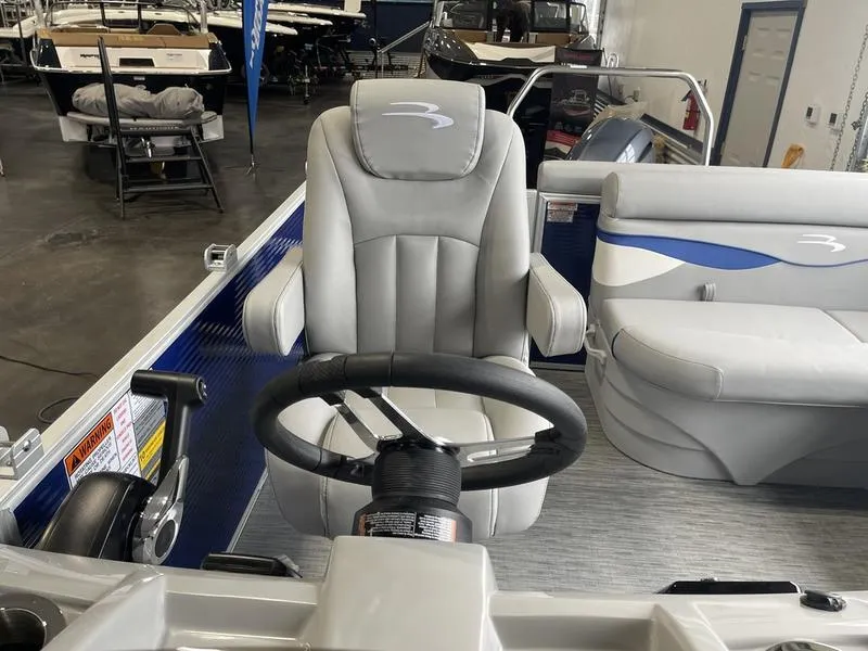 Slide: The Image of 2023 Bennington 218 SLJ boat interior with steering wheel and seating. - 9