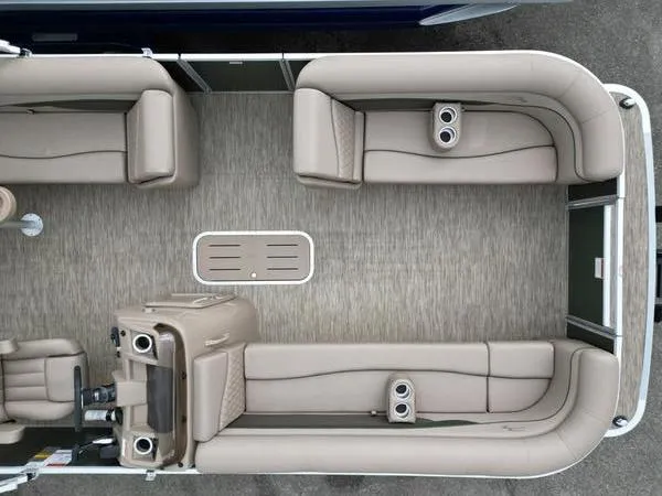 Slide: The Image of 2023 Bennington 22 SL pontoon boat interior with beige seating and cup holders. - 10