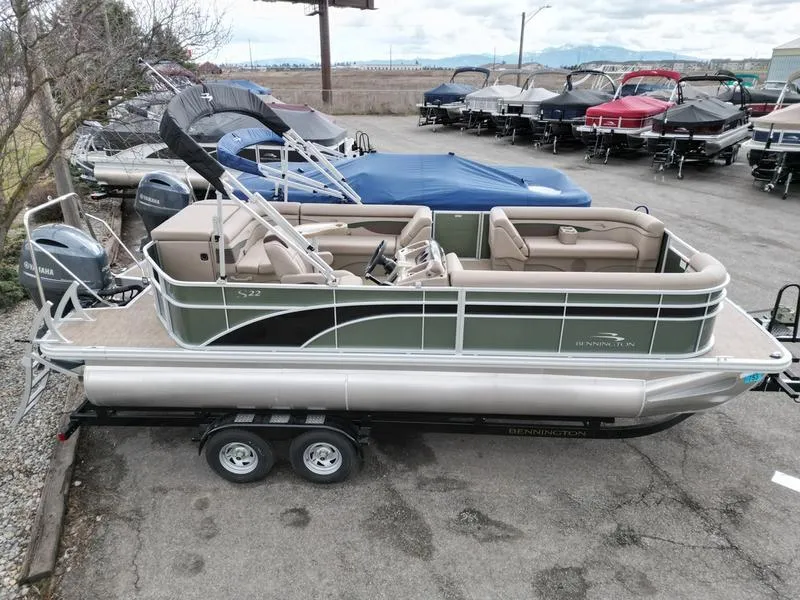 Slide: The Image of 2023 Bennington 22 SL pontoon boat on trailer in a marina lot. - 5