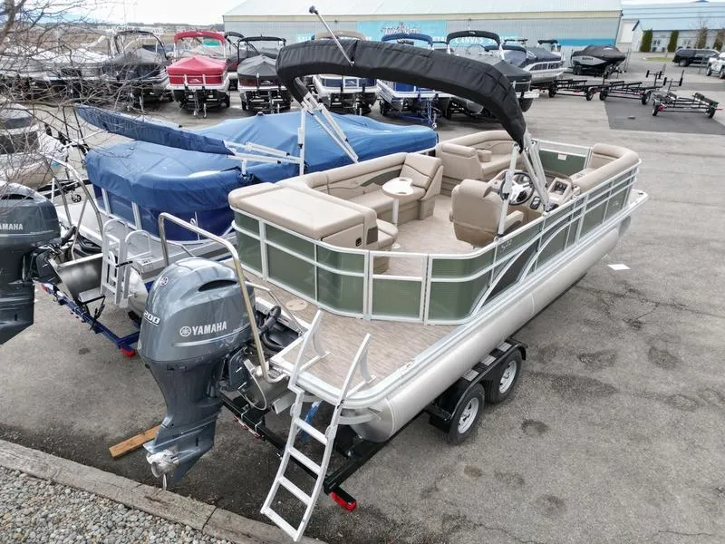 Slide: The Image of 2023 Bennington 22 SL pontoon boat with Yamaha motor, parked on a trailer. - 6