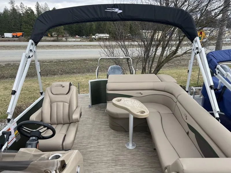 Slide: The Image of 2023 Bennington 22 SL pontoon boat with beige seating and canopy. - 7