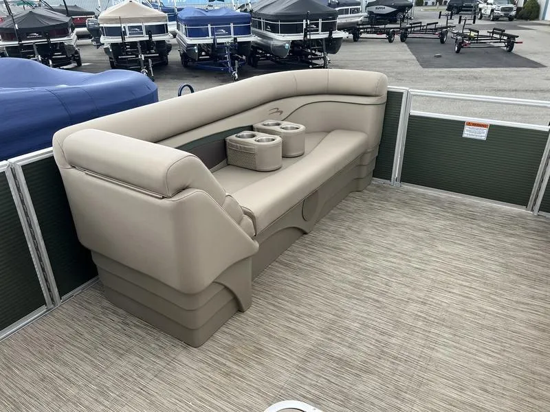 Slide: The Image of 2023 Bennington 22 SL pontoon boat interior with beige seating and cup holders. - 8