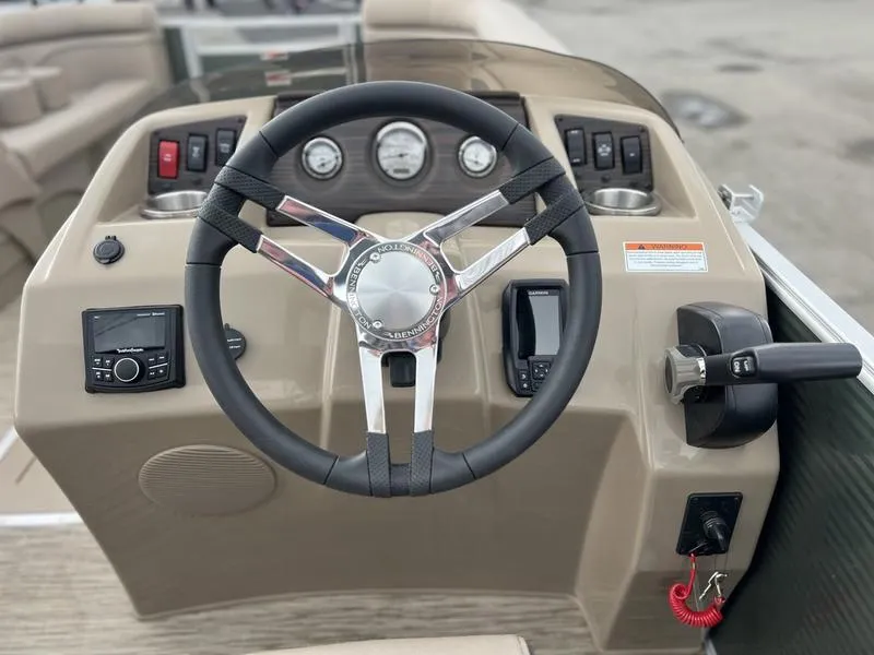 Slide: The Image of 2023 Bennington 22 SL boat dashboard with steering wheel and control panel. - 9