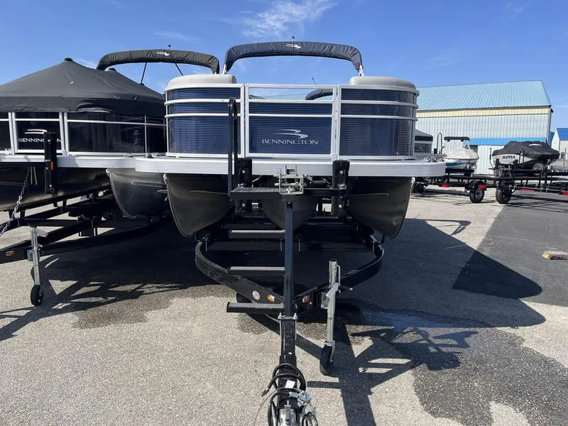 Slide: The Image of 2023 Bennington 22 SL pontoon boat on trailer in a parking lot. - 3
