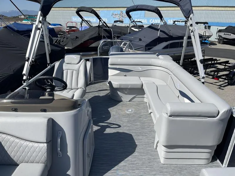 Slide: The Image of 2023 Bennington 22 SL pontoon boat with spacious seating and modern design. - 7