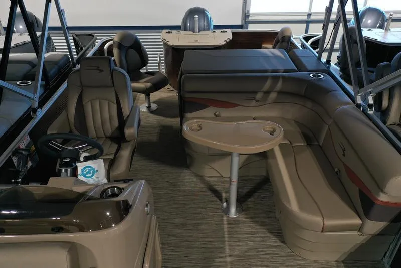 Slide: The Image of 2023 Bennington 22 SS pontoon boat interior with plush seating and steering console. - 12