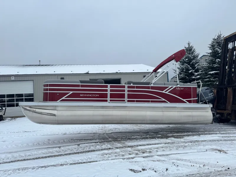 Slide: The Image of 2024 Bennington 22 SVL pontoon boat in snowy outdoor setting. - 1