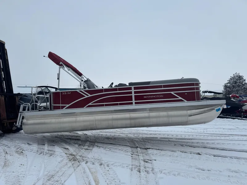 Slide: The Image of 2024 Bennington 22 SVL pontoon boat on snowy ground. - 3