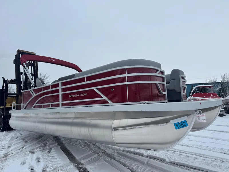 Slide: The Image of 2024 Bennington 22 SVL pontoon boat on snowy ground, red and silver design. - 4