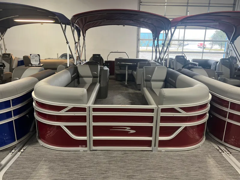 Slide: The Image of 2024 Bennington 22 SVL pontoon boat with red exterior and spacious seating. - 5