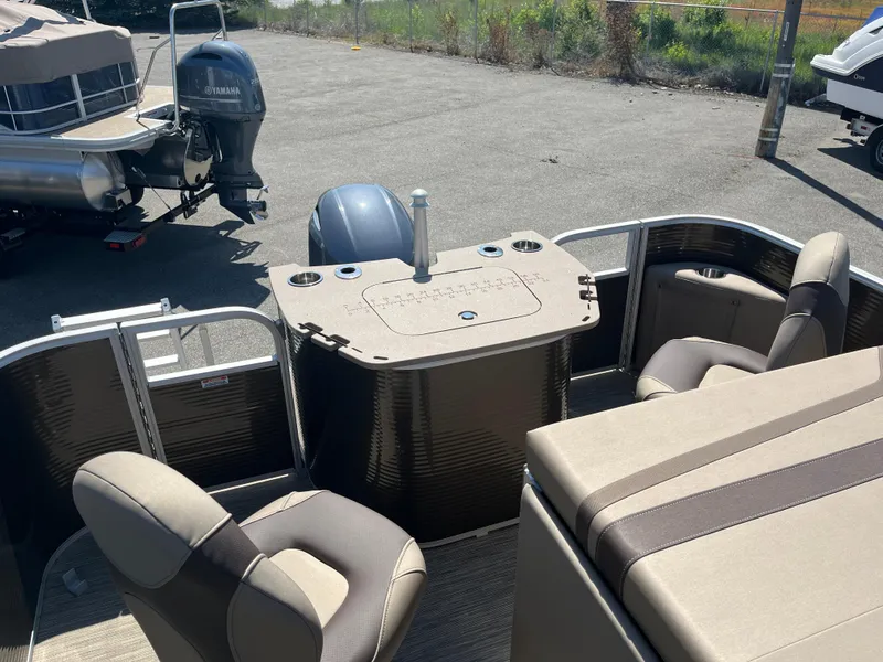 Slide: The Image of 2023 Bennington 22 SXFAPG pontoon boat interior with Yamaha motor, featuring seating and control console. - 10